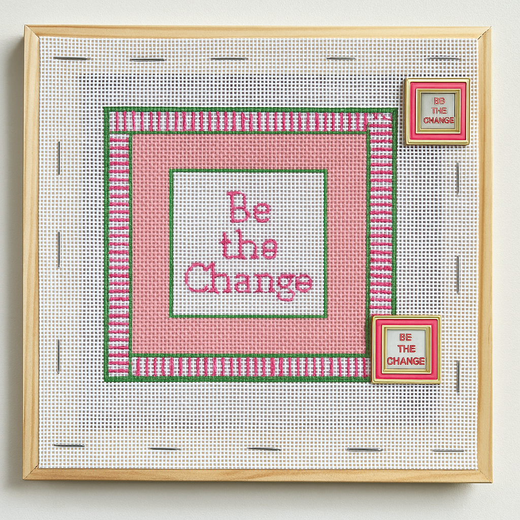 Needlepoint canvas with 'Be the Change' text and Be the Change needle Minders