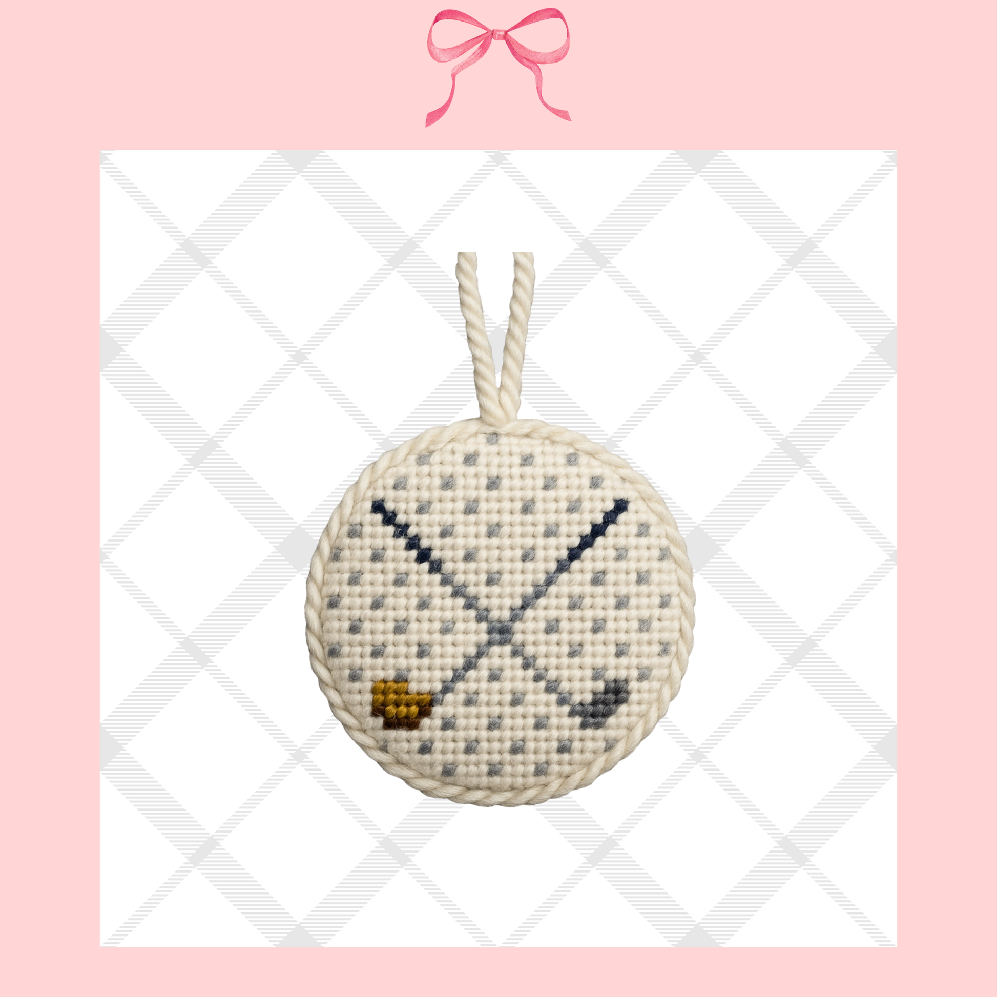 Small needlepoint ornament of a golf ball with golf clubs