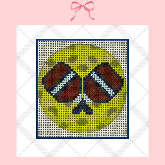 Hand painted needlepoint canvas of a pickle ball with paddles