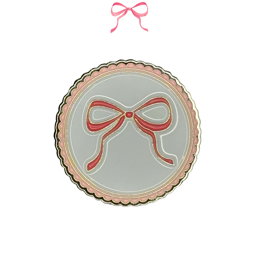 Metal Needle Minder with a bow design on a white background