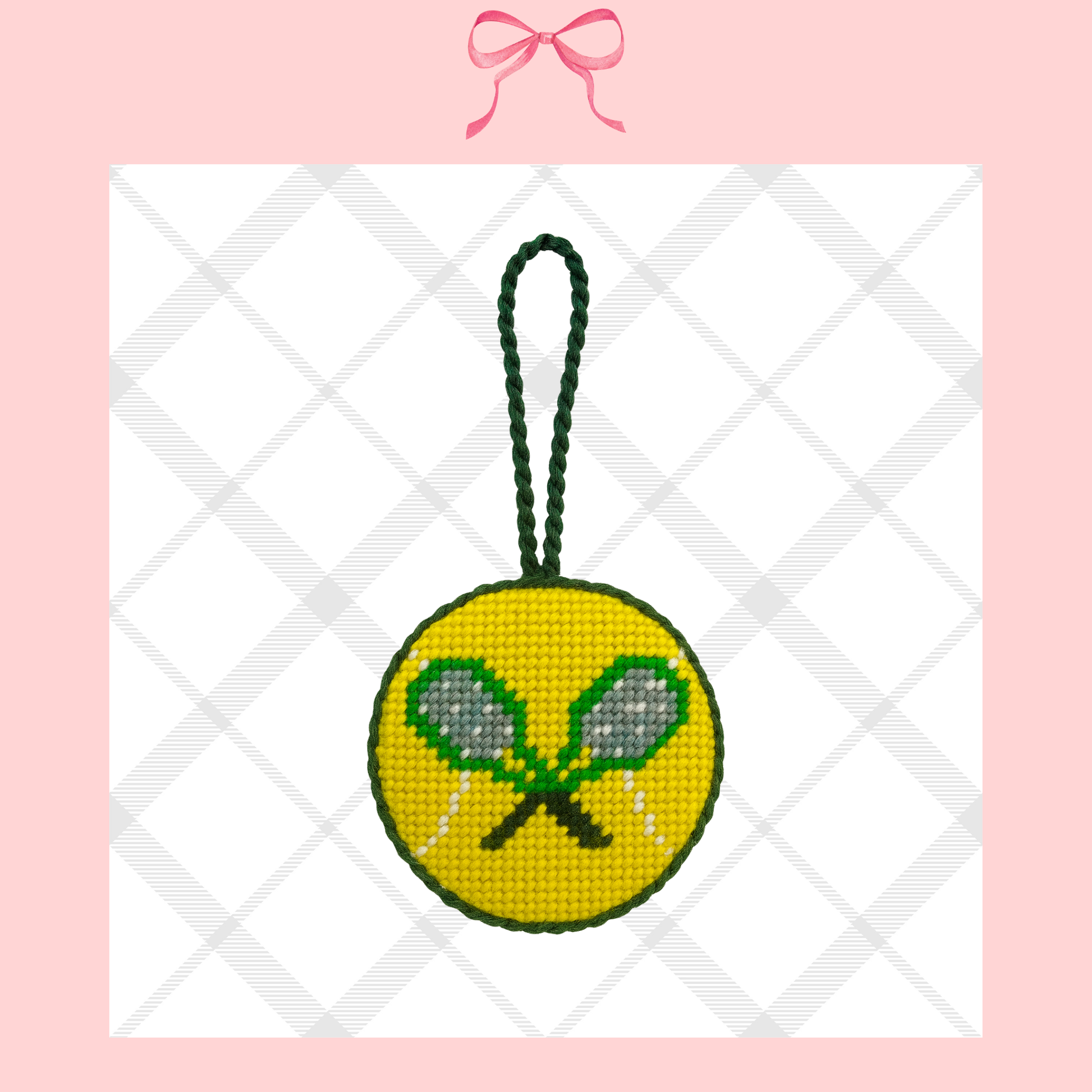 Needlepoint ornament with tennis rackets on a yellow tennis ball